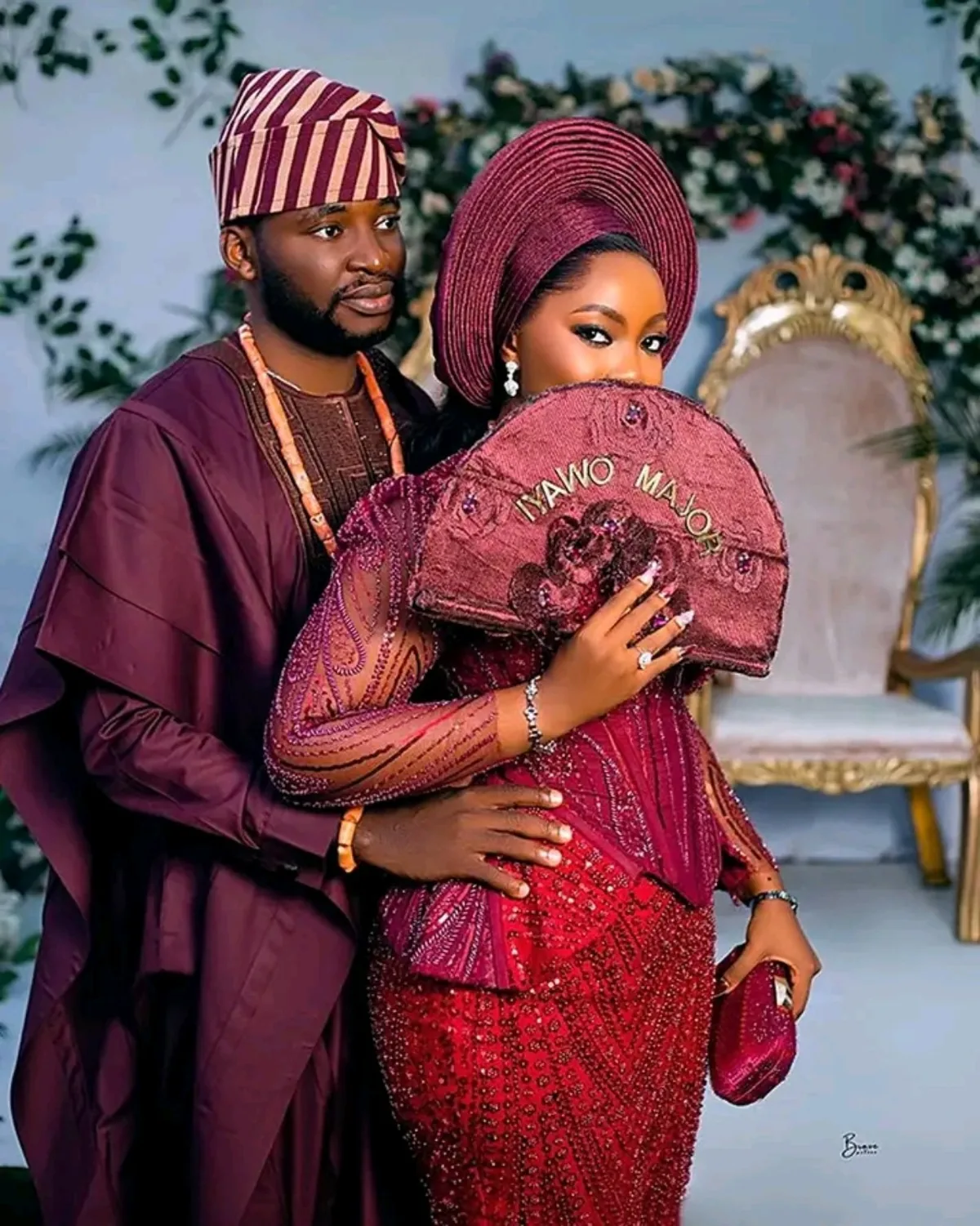 Traditional wedding couple in burgundy attire